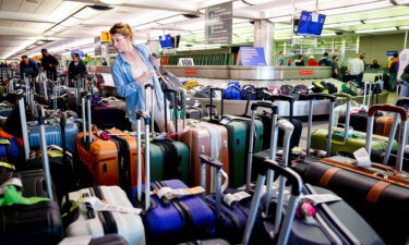 The cost of the service meltdown at Southwest Airlines over the year-end holidays cost the airline nearly $1 billion. A traveler is pictured here searching for a suitcase in a baggage holding area in December 2022 in Denver