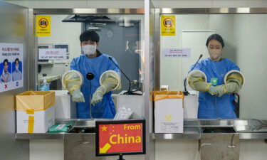 South Korean quarantine officials seen preparing PCR tests for travelers arriving from China at the Incheon International Airport near Seoul.