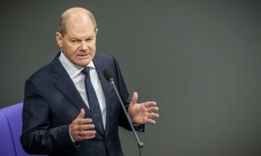 Chancellor Olaf Scholz speaks in Germany's Bundestag after announcing that his government would deliver Leopard battle tanks to Ukraine.