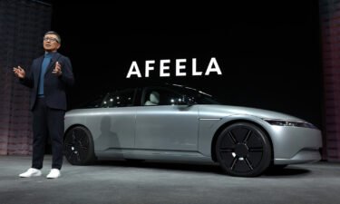 Sony Honda Mobility chief executive Yasuhide Mizuno is in front of an Afeela concept vehicle during a press event at CES 2023 on January 04