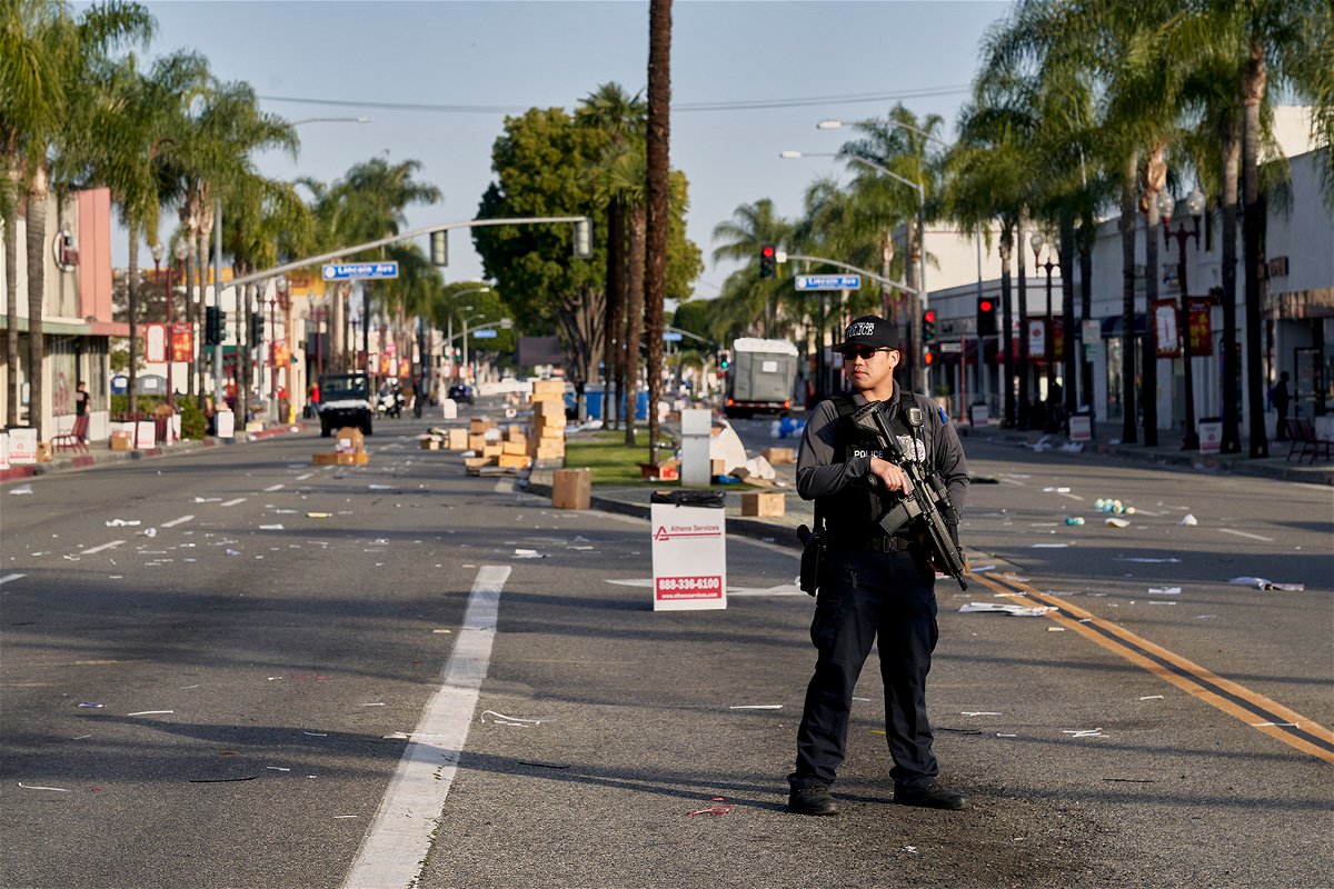 <i>Philip Cheung for The Washington Post/Getty Images</i><br/>A Monterey Park police officer stands guard near where vendor tents once stood for the Lunar New Year festival near the Star Dance Studio in Monterey Park