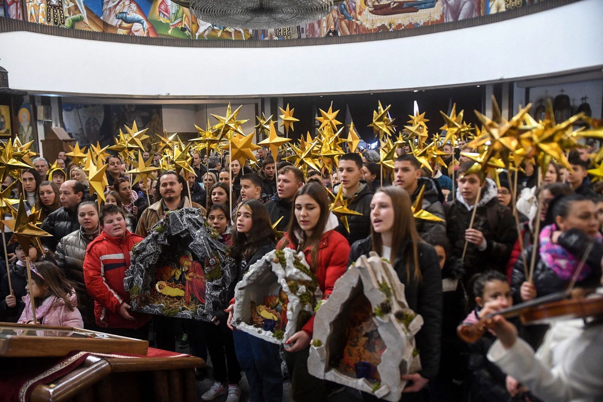 <i>Robert Atanasovski/AFP/Getty Images</i><br/>Young people hold a Birth of Christ diorama during a religious service to celebrate the Orthodox Christmas in St. Clement Cathedral in Skopje on January 6.