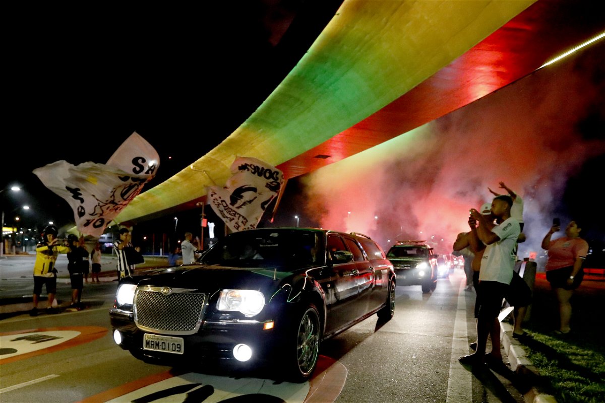 <i>Ricardo Moreira/Getty Images South America/Getty Images</i><br/>The hearse carrying Pele's coffin arrives into Santos as a firework goes off in the early morning ahead of the wake.