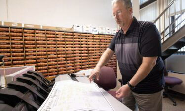 Map preservationist Ron Koch stands beside the scanner he used to digitize the original document in the records office at the Woodbury County Courthouse in Sioux City on January 17