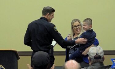 3-year-old Aaron Davenport is sworn in as an honorary officer with the Redmond Police department before his latest surgery to remove a brain tumor.