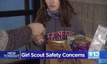A Girl Scout is handed money for cookies at a pop-up booth at Granite Bay. The troop leader said