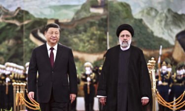 Iranian President Ebrahim Raisi walks with Chinese President Xi Jinping during a welcome ceremony at the Great Hall of the People in Beijing on Tuesday