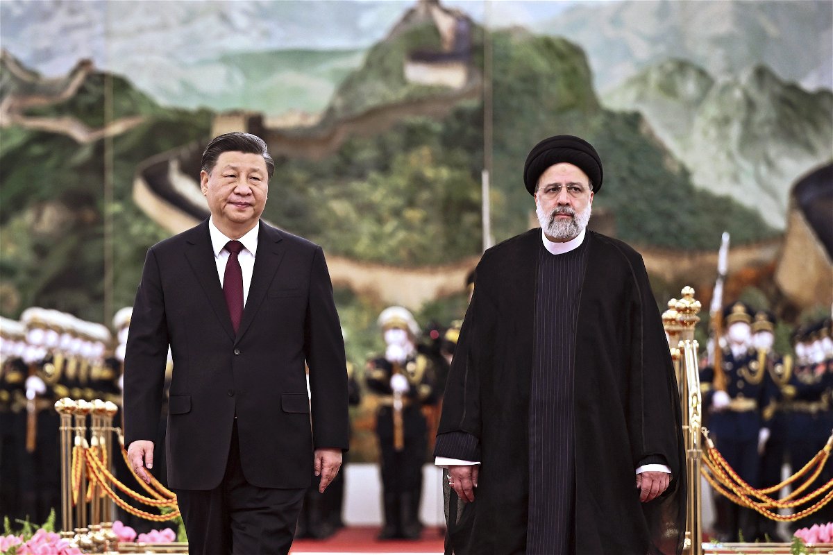 <i>Yan Yan/Xinhua/AP</i><br/>Iranian President Ebrahim Raisi walks with Chinese President Xi Jinping during a welcome ceremony at the Great Hall of the People in Beijing on Tuesday