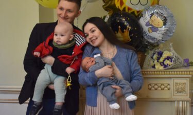 Mikhail and Nailia Manzurin pose with their two children