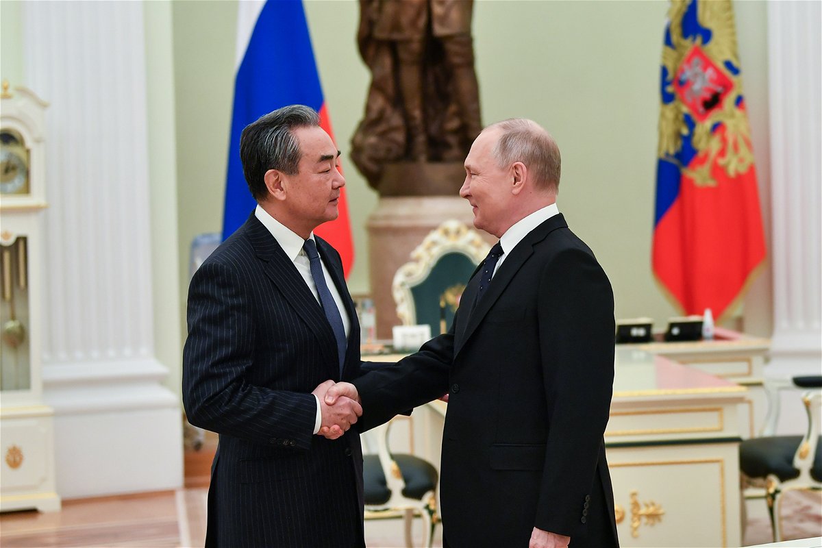<i>Cao Yang/Xinhua/Getty Images/FILE</i><br/>Russian President Vladimir Putin (right) meets Wang Yi