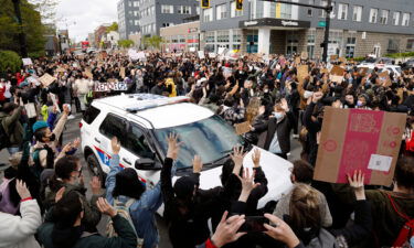 Ohio State students surround a police vehicle on April 21
