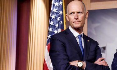 Sen. Rick Scott listens during a news conference at the Capitol Building on January 25 in Washington.