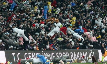 Toys are passed onto the pitch for children affected by the earthquake in Turkey and Syria.