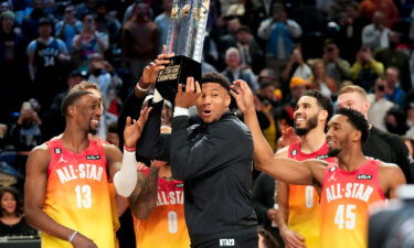 Team captain Giannis Antetokounmpo holds up the winning team trophy after the NBA All-Star game on Sunday night.