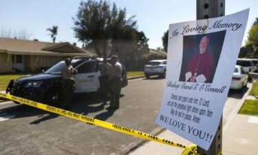 Los Angeles County Sheriff deputies guard the entrance to the street of Bishop David O'Connell's home in Hacienda Heights