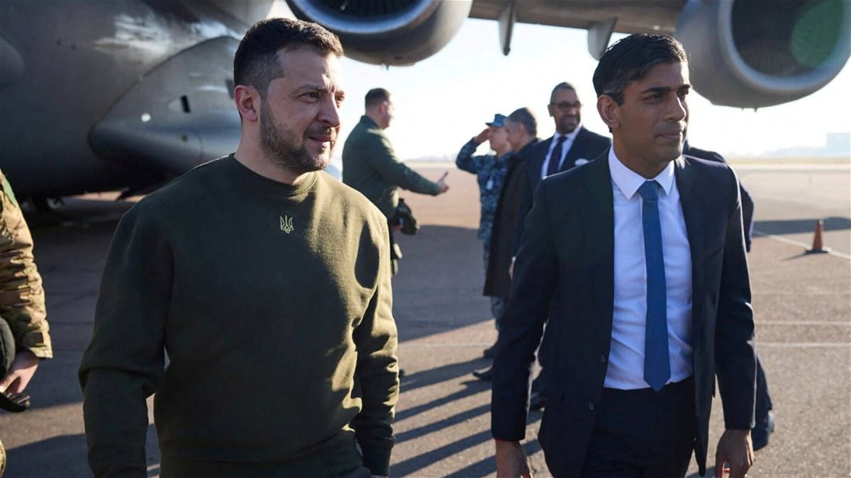 <i>Ukrainian Presidential Press Service/Reuters</i><br/>Volodymyr Zelensky walks alongside Rishi Sunak at London's Stansted airport on February 8.