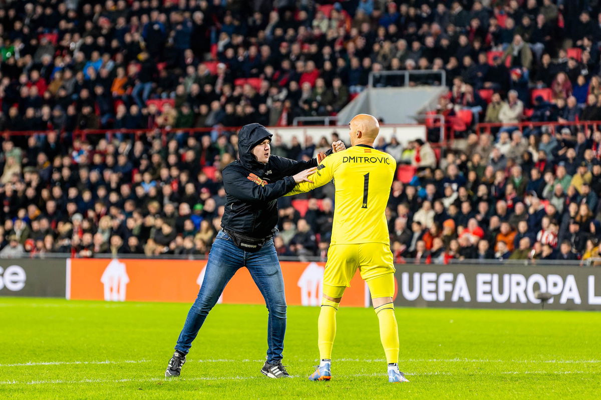 <i>ProShots/Icon Sport/Getty Images</i><br/>A pitch invader aimed a punch at Sevilla goalkeeper Marko Dmitrović during the game against PSV.