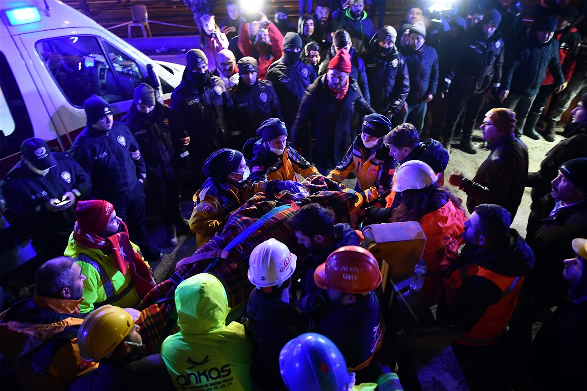 <i>Adsiz Gunebakan/Anadolu Agency/Getty Images</i><br/>A family is rescued from the rubble of a collapsed building after 40 hours of search and rescue efforts on February 7 in Turkey.