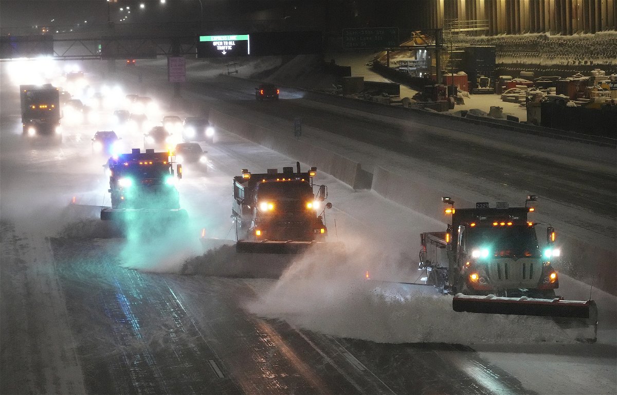 <i>David Joles/Star Tribune/AP</i><br/>Plows move snow from I-35W southbound seen from the 42nd St. Bridge on Wednesday in Minneapolis.