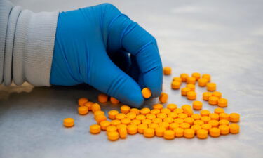 A Drug Enforcement Administration (DEA) chemist checks confiscated powder containing fentanyl at the DEA Northeast Regional Laboratory on October 8