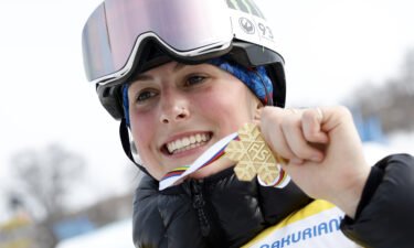 Mia Brookes poses with her gold medal at the FIS Snowboard World Championships.