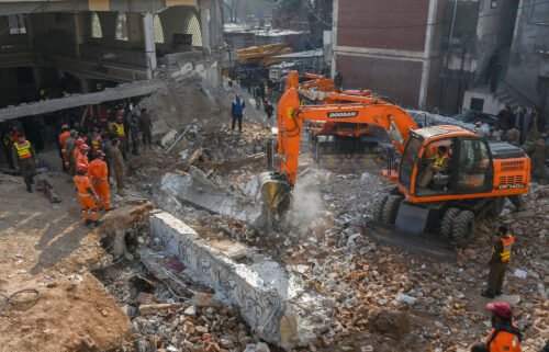 Security personnel and rescue workers search for survivors amid the debris of the mosque in Peshawar on January 31.