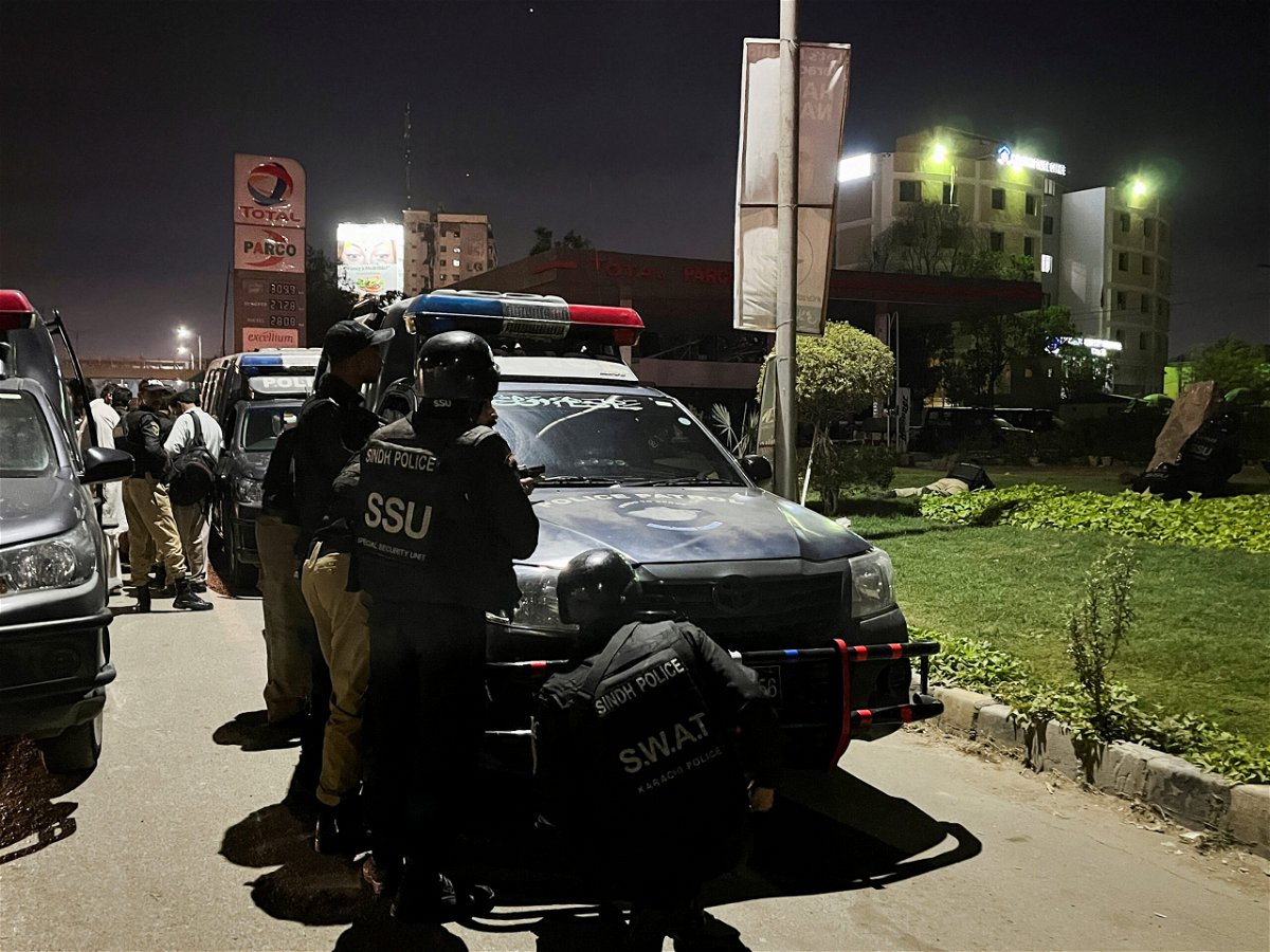 <i>Akhtar Soomro/Reuters</i><br/>Police officers take position after Friday's attack by gunmen in Karachi.