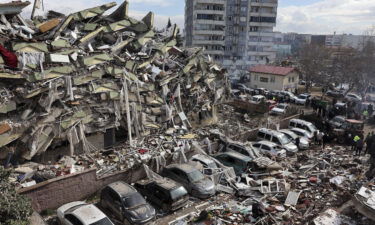 Rescuers and civilians look for survivors under the rubble of collapsed buildings in Kahramanmaras