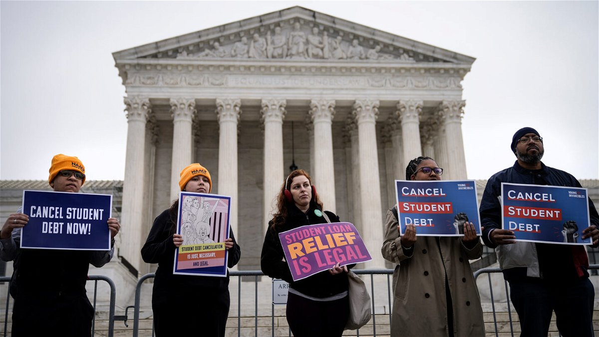 <i>Drew Angerer/Getty Images</i><br/>People rally in support of the Biden administration's student debt relief plan in front of the the U.S. Supreme Court on February 28