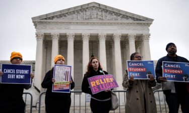 People rally in support of the Biden administration's student debt relief plan in front of the the U.S. Supreme Court on February 28