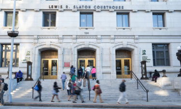 People walk around outside The Fulton County Court House on September 29