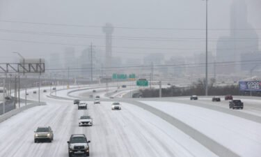 Vehicles drive on an icy highway Tuesday as an ice storm moves through Dallas