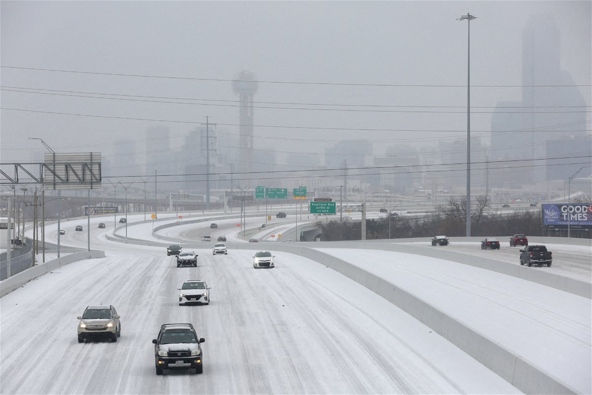 <i>Shelby Tauber/Reuters</i><br/>Vehicles drive on an icy highway Tuesday as an ice storm moves through Dallas