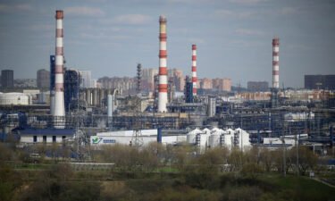 Russia will cut crude oil production by half a million barrels per day starting in March. Pictured is a Russian oil refinery on the south-eastern outskirts of Moscow on April 28