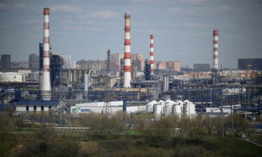 Russia will cut crude oil production by half a million barrels per day starting in March. Pictured is a Russian oil refinery on the south-eastern outskirts of Moscow on April 28