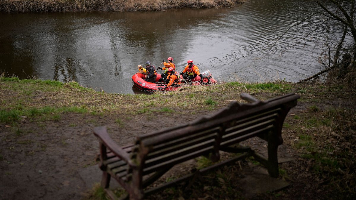 <i>Christopher Furlong/Getty Images</i><br/>A search dog from Lancashire Police and a crew from Lancashire Fire and Rescue service search the River Wyre near the bench where Bulley's mobile phone was found