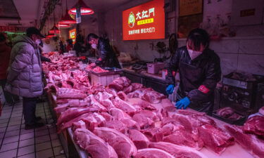 Beijing will give out a $6 monthly cash subsidy to offset inflation. Pork is for sale at a wholesale market in Beijing on January 12.