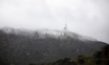 The Hollywood sign is seen through a mix of fog and dust snow during a rare cold winter storm in the Los Angeles area.