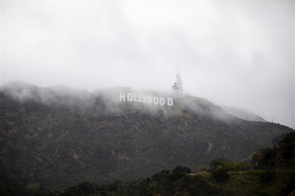 <i>Aude Guerrucci/Reuters</i><br/>The Hollywood sign is seen through a mix of fog and dust snow during a rare cold winter storm in the Los Angeles area.