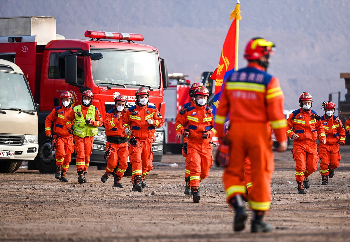 <i>Chine Nouvelle/SIPA/Shutterstock</i><br/>Rescue workers gather at the site.