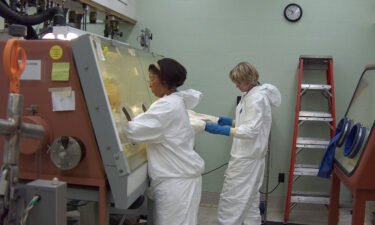 Clarice Phelps works in 2012 to purify the element berkelium as fellow scientist Shelley VanCleve observes at Oak Ridge National Lab in Tennessee.
