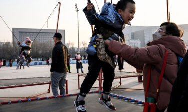 China is planning to offer free fertility treatment to citizens to boost its record low birth rate. Children jump on trampolines in Beijing on February 5.