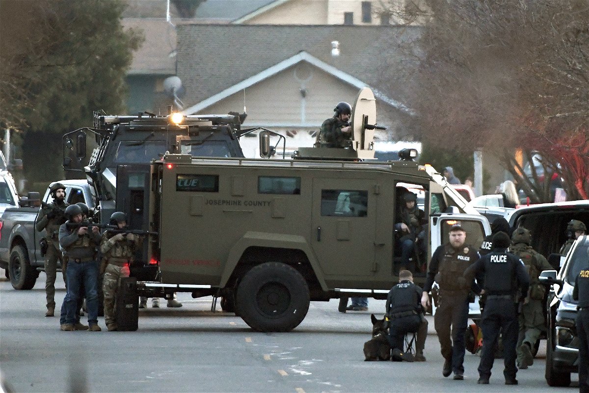 <i>Scott Stoddard/AP</i><br/>Law enforcement officers are seen here during a standoff with the kidnapping suspect in Grants Pass