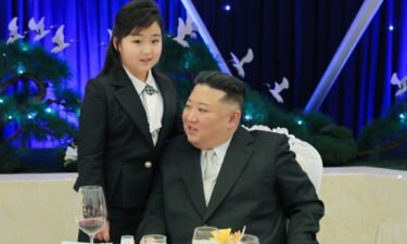KIm Jong Un is pictured with a girl believed his daughter at a military banquet on Tuesday.