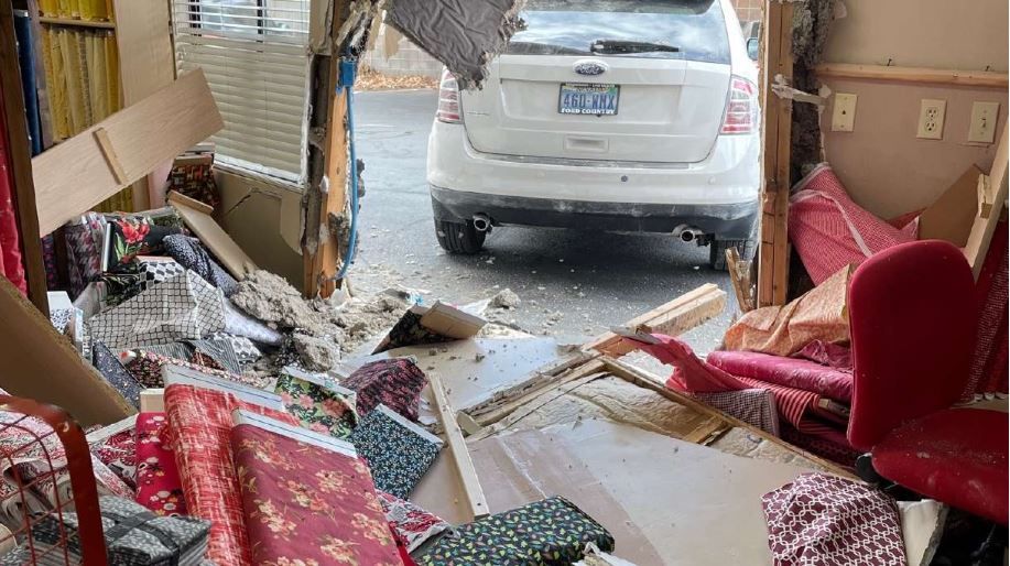 <i></i><br/>A car crashed into a quilting store in Washington County after police say the driver's shoe slipped off and became stuck between the brake and gas pedal.