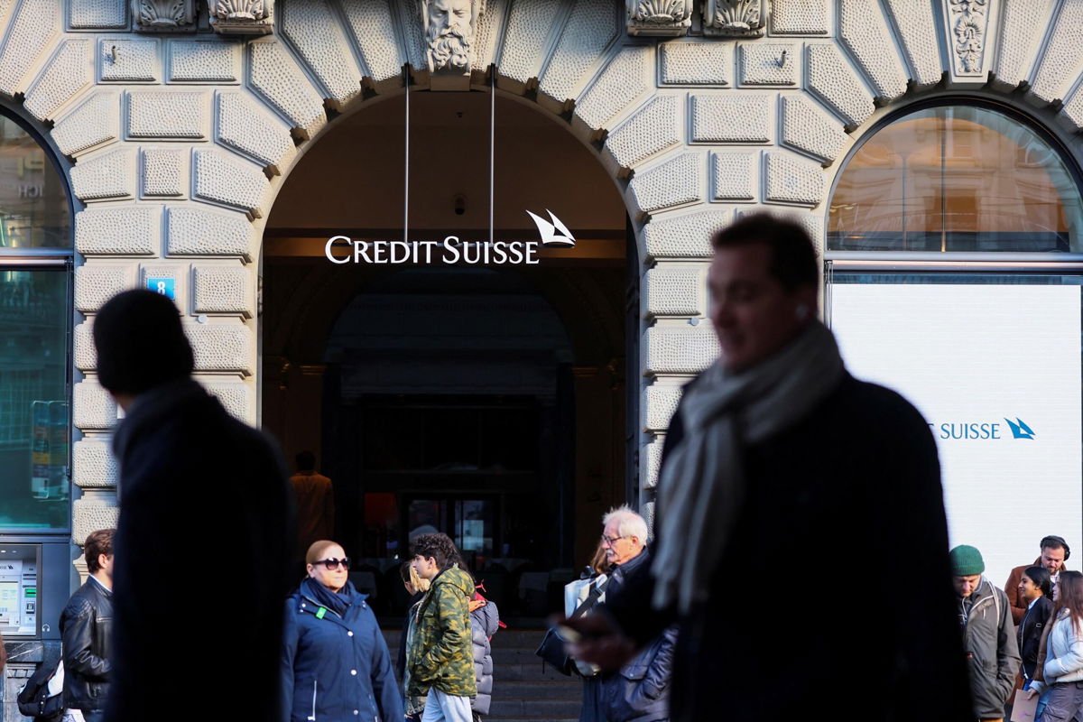 <i>Denis Balibouse/Reuters</i><br/>People walk near the logo of the Swiss bank Credit Suisse in Zurich