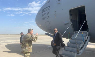 Defense Secretary Lloyd Austin is greeted by Major General Matthew McFarlane