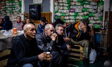 Ukrainians watch a movie on TV at a humanitarian aid centre in Bakhmut on Monday