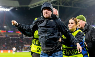 The fan was escorted from the pitch by security.