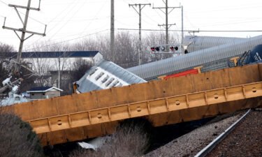 Multiple cars of a Norfolk Southern train lie toppled on one another after derailing at a train crossing with Ohio 41 in Clark County